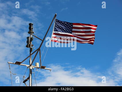 Maritime Windy American Stars and Stripes Flag on Ship Pole with Blue Sky Stock Photo