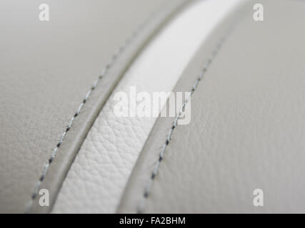 Close up of a stitch on a piece of leather fragment chair upholstery. Stock Photo