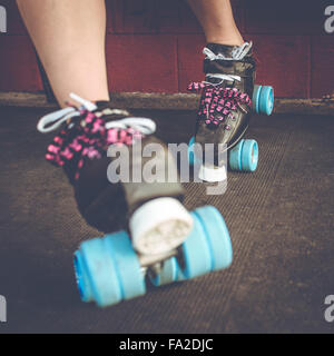 Roller derby, roller skating woman outside of roller rink with roller skates on. Stock Photo