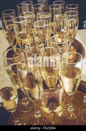Freshly poured champagne, prepared for a toast. Stock Photo