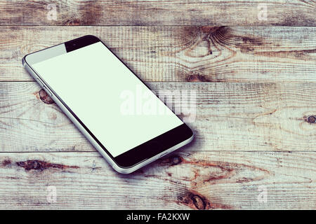Realistic mobile phone with blank screen on wooden background. Highly detailed illustration. Stock Photo