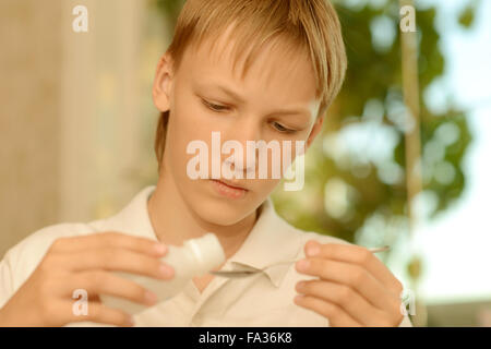 sick teenager taking medication Stock Photo