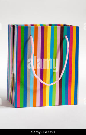 colourful multi coloured striped gift bag giftbag with handles isolated on white background Stock Photo
