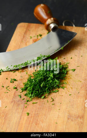 https://l450v.alamy.com/450v/fa3d41/chopping-fresh-dill-with-a-curved-mezzaluna-knife-fa3d41.jpg