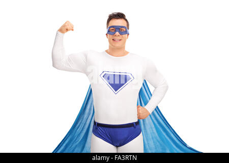 Young man in a superhero costume flexing his biceps and looking at the camera isolated on white background Stock Photo