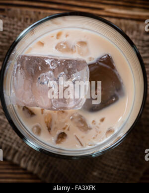 Irish Cream Liqueur (detailed close-up shot) on wooden background Stock Photo