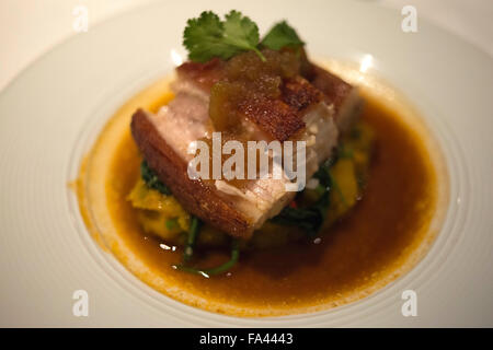 Thai food The crispy pork belly with roasted pumplin puree, work fried morning glory, apple ginger marmalade and traditional por Stock Photo