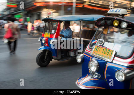 Tuk tuks taxi in the street. View down Thanon Yaowarat road at night in central Chinatown district of Bangkok Thailand. Yaowarat Stock Photo