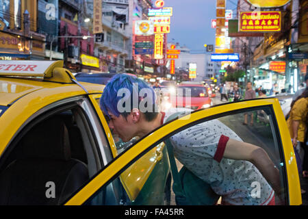 Taxi in the street. View down Thanon Yaowarat road at night in central Chinatown district of Bangkok Thailand. Yaowarat and Phah Stock Photo