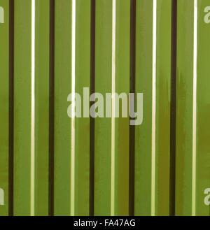 Diagonal pattern of metal profile. Fences from the galvanized iron painted by a polymeric covering. Stock Photo