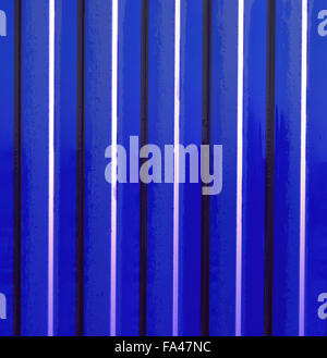 Diagonal pattern of metal profile. Fences from the galvanized iron painted by a polymeric covering. Stock Photo
