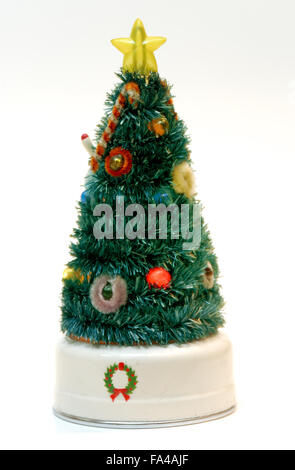 An antique Christmas tree decoration with ornaments that light and a star on top. Stock Photo