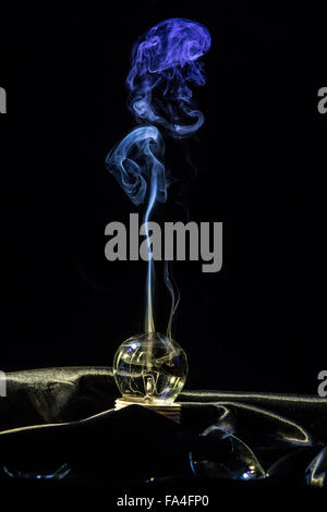 Smoking broken light bulb Stock Photo