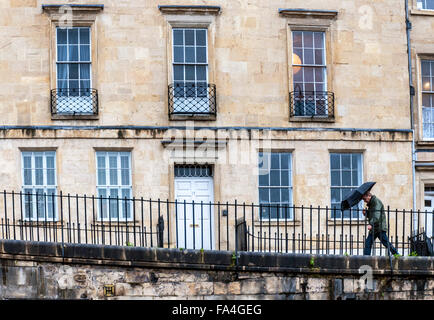 Bath, Somerset, UK. 21st December 2015. UK Weather: Wind and rain as a man walks past the classic architecture of the spa city. Credit:  Richard Wayman/Alamy Live News Stock Photo