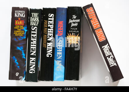 row of Stephen King books including Four Past Midnight, The Dark Half, the Stand, Night Shift, Misery and Four Novels by Stephen King on white Stock Photo
