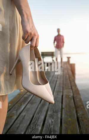 Mature man waiting for her wife on pier at lake, Bavaria, Germany Stock Photo