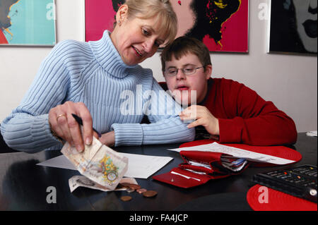 Single parent counting out money with her son, Stock Photo