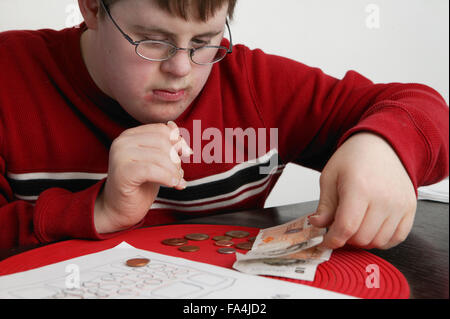 Boy counting out money, Stock Photo