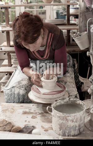 Female potter moulding clay in workshop, Bavaria, Germany Stock Photo
