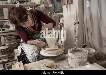 Female potter moulding clay in workshop, Bavaria, Germany Stock Photo