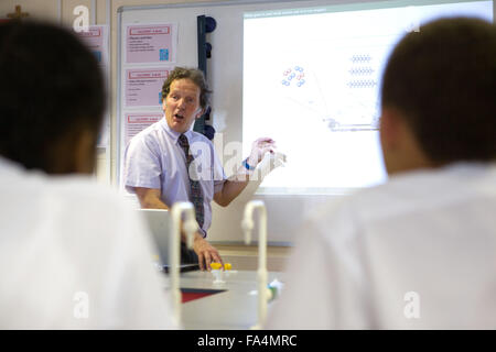 Secondary School teacher using the whiteboard to explain the background to car combustion and air quality Stock Photo