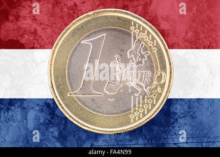 Common face of one euro coin from Netherlands isolated on the national dutch flag as background Stock Photo