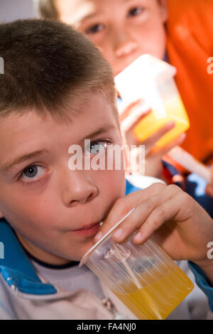 Children drinking from juice cartons, Stock Photo