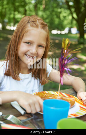 Portrait of a girl eating food at picnic, Munich, Bavaria, Germany Stock Photo