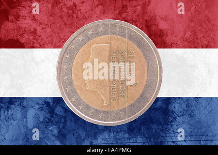 Two euros coin from Netherlands isolated on the national dutch flag as background Stock Photo