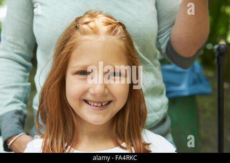 Portrait of a girl smiling with her mother in picnic, Munich, Bavaria, Germany Stock Photo