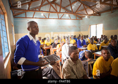 Students attend school in a classroom lit by solar power in Nyarubanda village, Kigoma Region, Western Tanzania. Stock Photo
