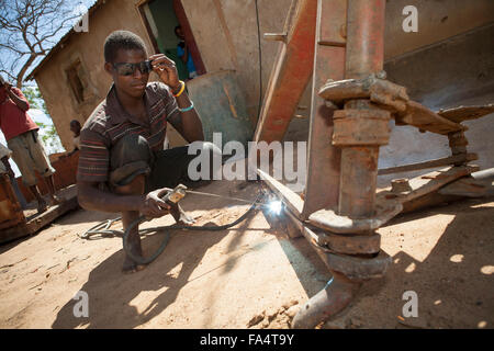A man operates an electric-powered welding maching in Dodoma, Tanzania, East Africa. Stock Photo