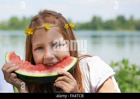 Girl enjoying slice of watermelon at picnic, Munich, Bavaria, Germany Stock Photo
