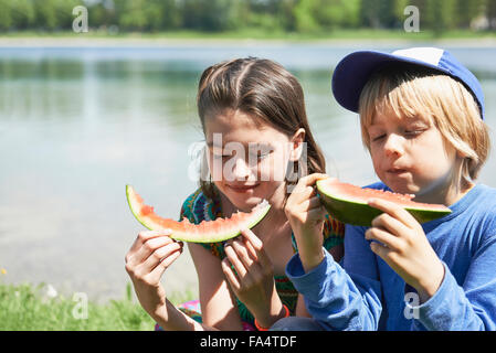 Children enjoying slices of watermelon at picnic, Munich, Bavaria, Germany Stock Photo