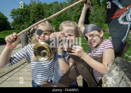 Three girls playing on a pirate ship in adventure playground, Bavaria, Germany Stock Photo