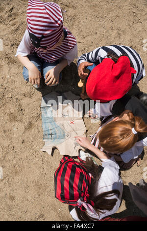 Directly above shot of children examining a treasure map in a adventure playground, Bavaria, Germany Stock Photo