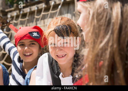 Three girls smiling in a playground, Bavaria, Germany Stock Photo