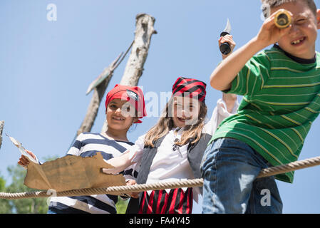 Children playing pirate game in adventure playground, Bavaria, Germany Stock Photo