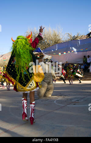 Dancers in traditional costumes and masks, spectators, musicians in a parade at the 500 year celebration of Luribay, Bolivia Stock Photo