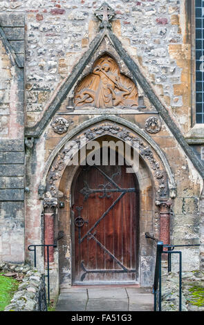 Llandaff Cathedral door on the south side, depicting St Michael slaying the dragon Stock Photo