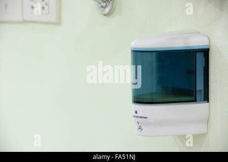 automatic soap dispenser on the wall Stock Photo