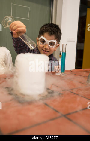Schoolboy mixing liquid in chemistry class, Fürstenfeldbruck, Bavaria, Germany Stock Photo