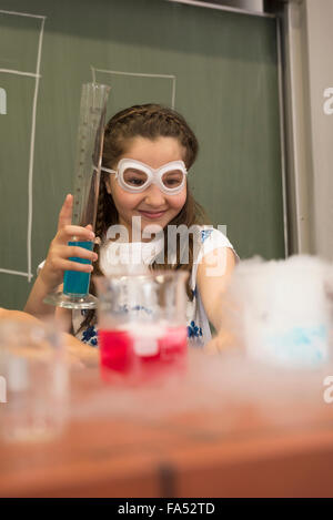 Schoolgirl mixing liquid in chemistry class, Fürstenfeldbruck, Bavaria, Germany Stock Photo