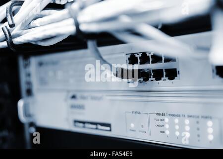 Networking patch cable plug to the ethernet RJ45 port in networking switch. Stock Photo