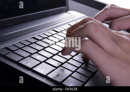 typing on computer laptop Stock Photo