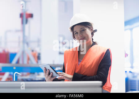 Female engineer using a digital tablet in an industrial plant, Freiburg Im Breisgau, Baden-Württemberg, Germany Stock Photo