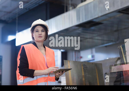 Female engineer using a digital tablet in an industrial plant, Freiburg Im Breisgau, Baden-Württemberg, Germany Stock Photo