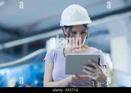 Female engineer using a digital tablet in an industrial plant, Freiburg Im Breisgau, Baden-Württemberg, Germany Stock Photo