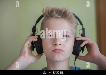 Portrait of a boy listening to music with headphones, Freiburg im Breisgau, Baden-Württemberg, Germany Stock Photo