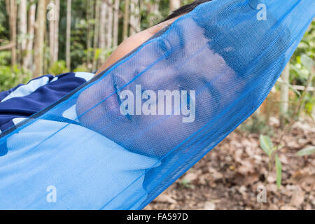 Asian teen man relax in the garden during holiday after work Stock Photo